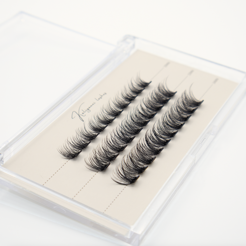 Kaliyanei pre-mapped lash clusters arranged in three rows inside a clear case