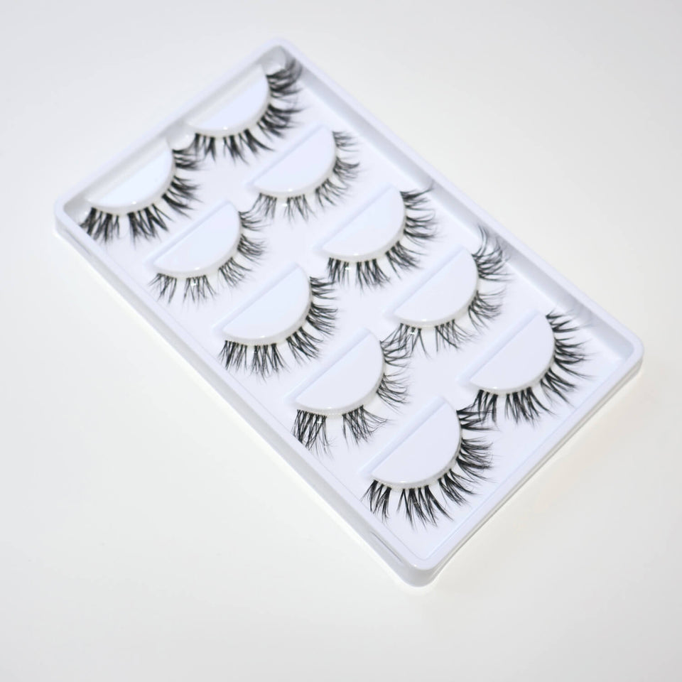 Black DIY cluster lashes in white tray, designed for natural everyday wear and soft glam looks.