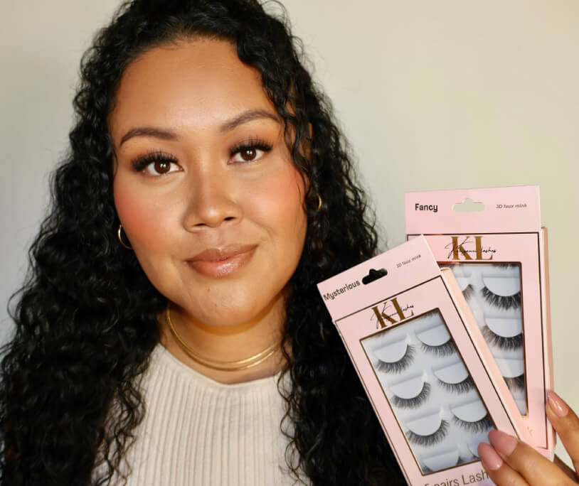 Makeup artist holding Kaliyanei Lashes strip lash packs, showcasing professional lash styles for glam makeup looks.