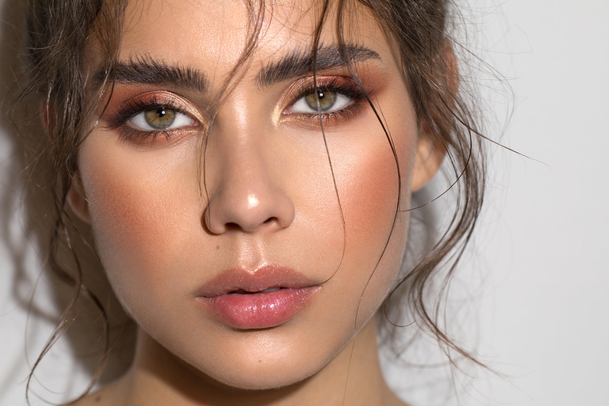 Model wearing natural wispy false lashes with soft glam makeup for everyday wear