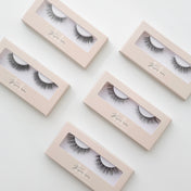 Pair Strip Lash by Kaliyanei Lashes – Flatlay of Lash Boxes in Beige Packaging on Light Background