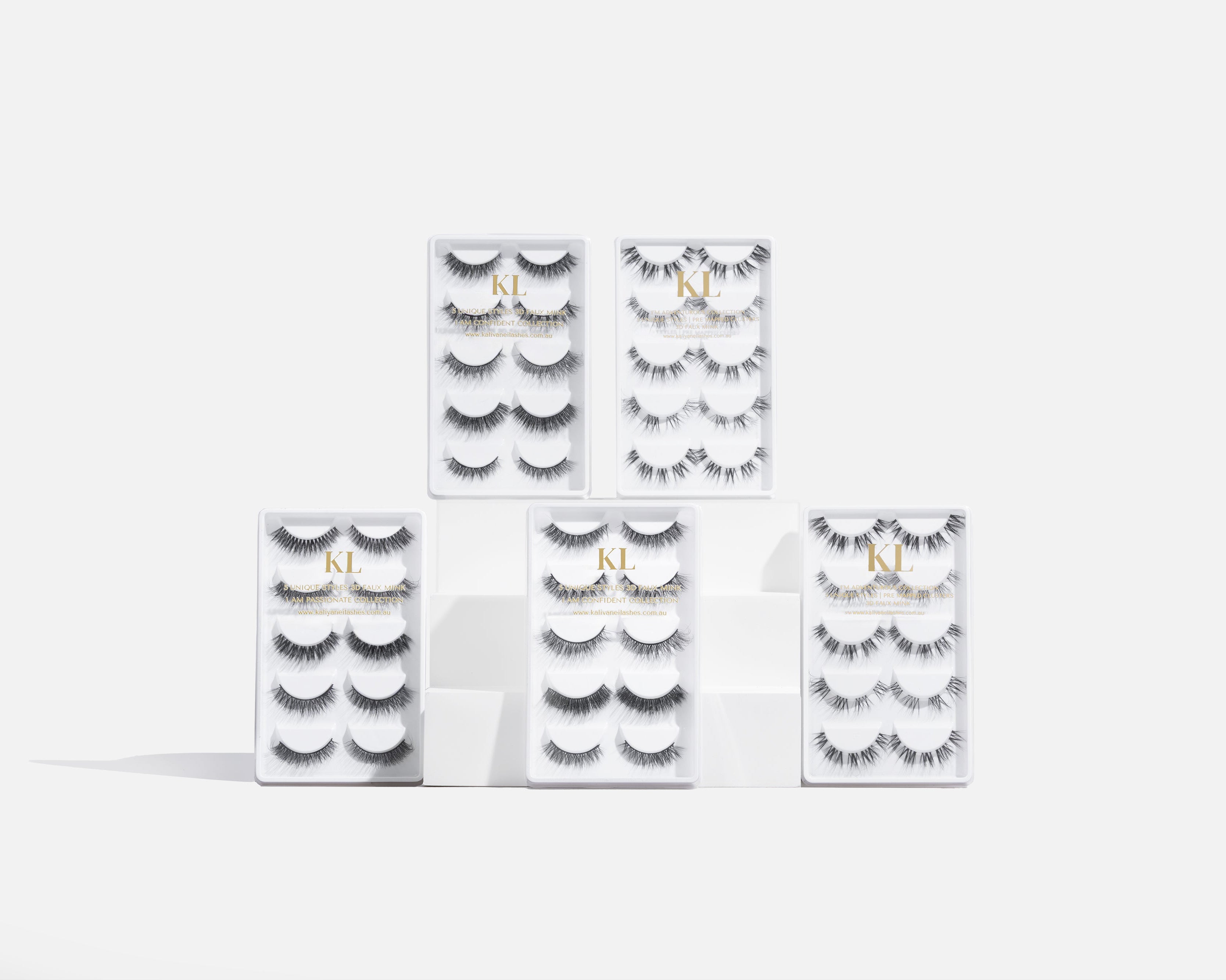 multi-style false lash set in clear packaging displayed on white platform